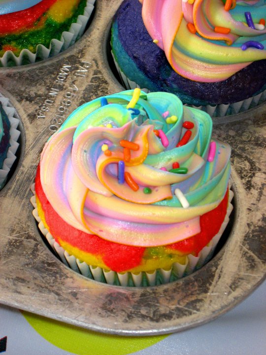 Close-up of a rainbow cupcake in a metal cupcake tin