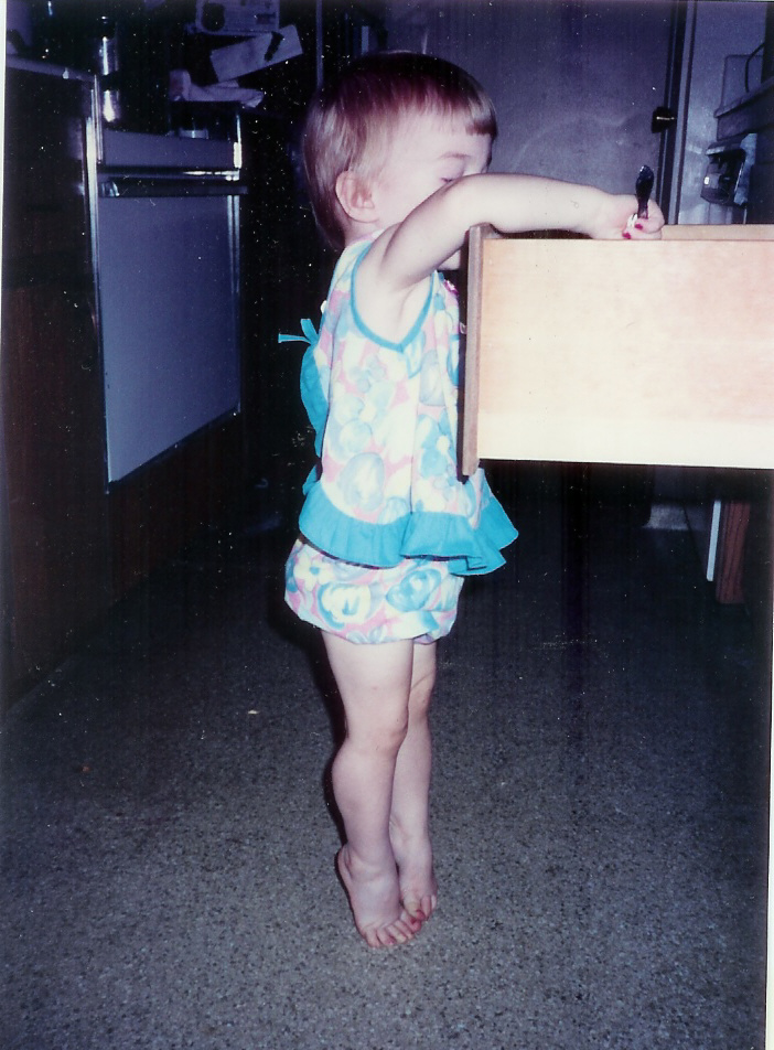 A photo of the blogger as a baby looking into an opened drawer