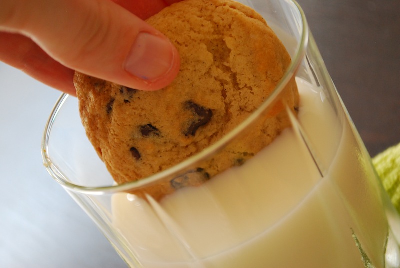 A vanilla bean chocolate chip cookie dunked in milk