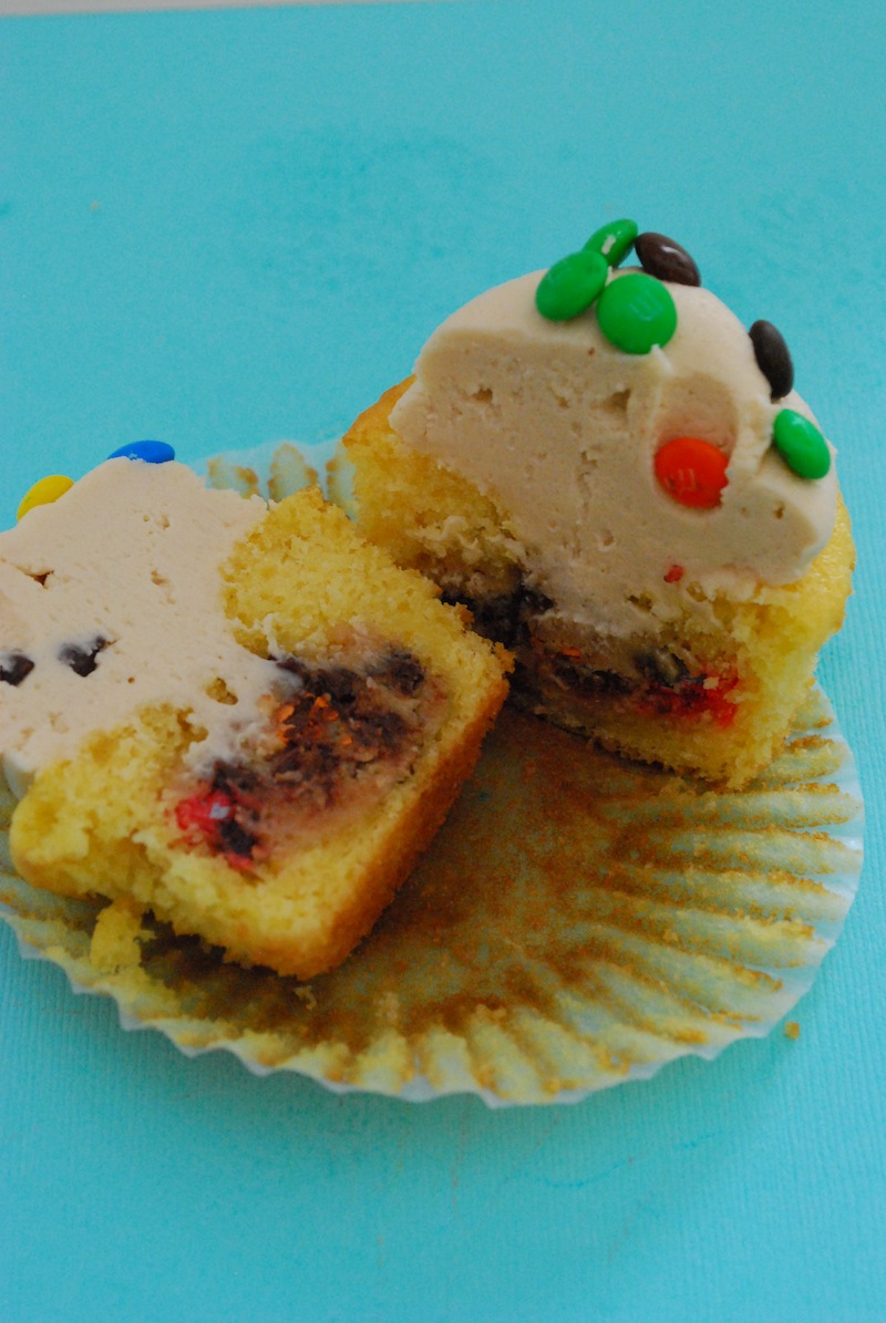 Monster cookie dough cupcake split in half to show the inside