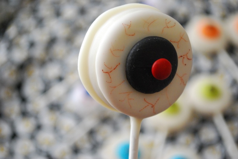 Close-up of an eyeball Oreo pop with a black "iris" and red "pupil"