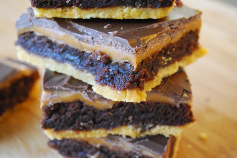 Close-up of a stack of Twix brownies on a wooden background