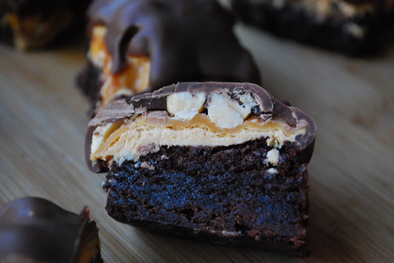 the interior of a snickers brownie bite on a wood background
