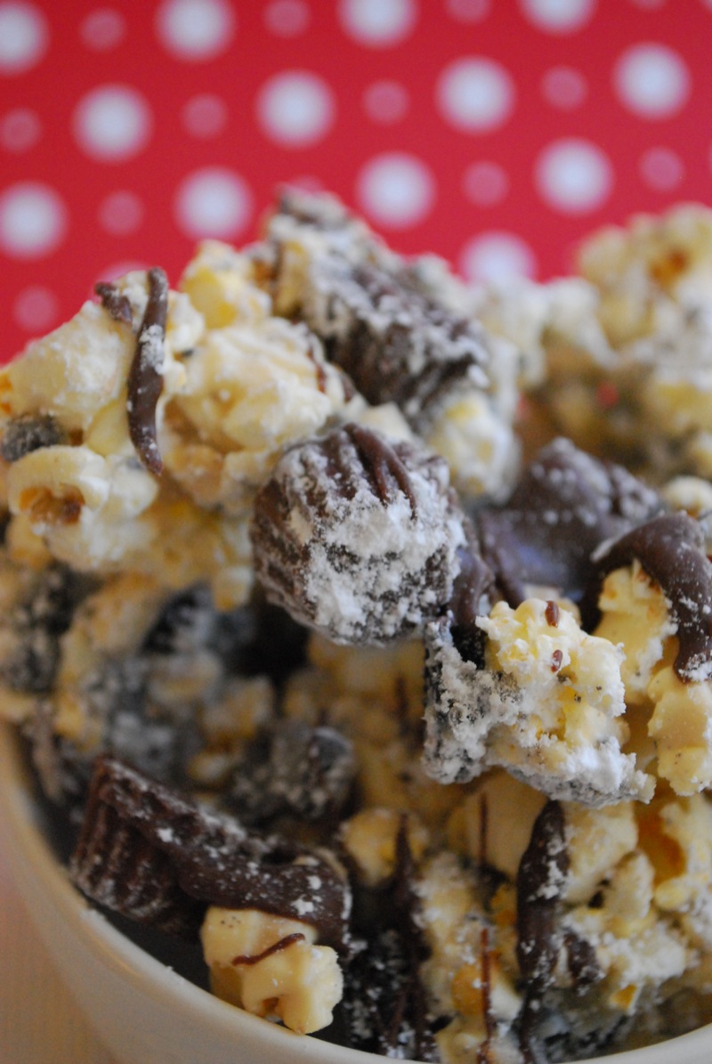 Close-up of cookies and cream Reese's cup puppy chow popcorn in a white bowl