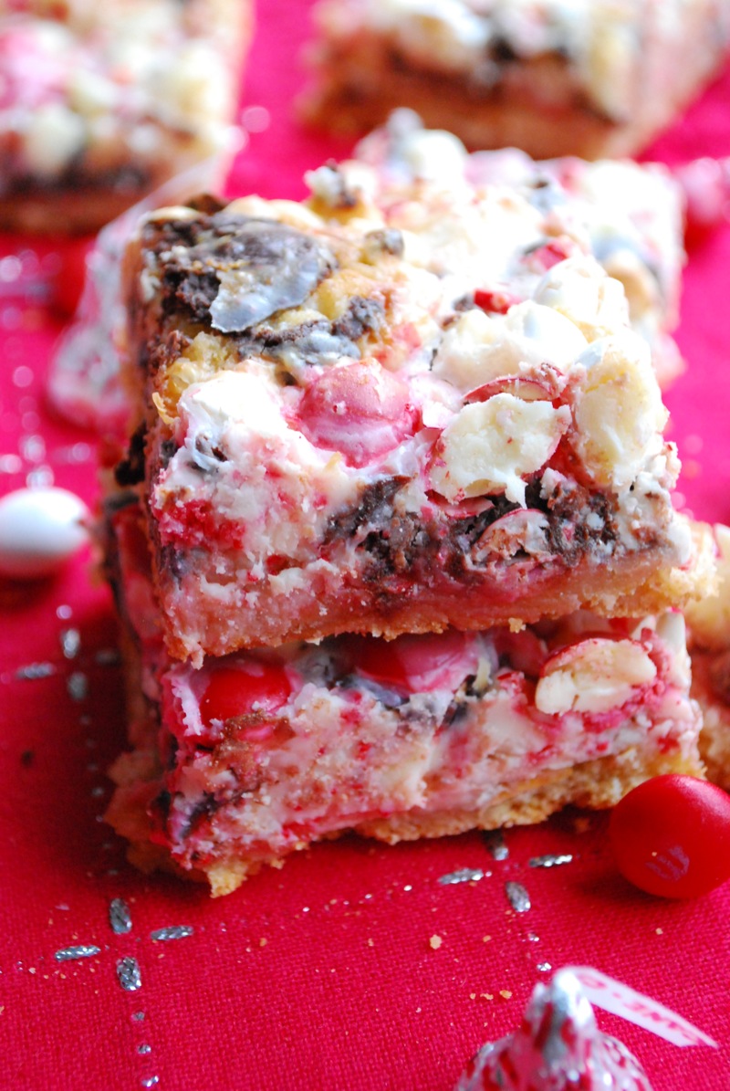 Two peppermint seven layer bars on a red cloth