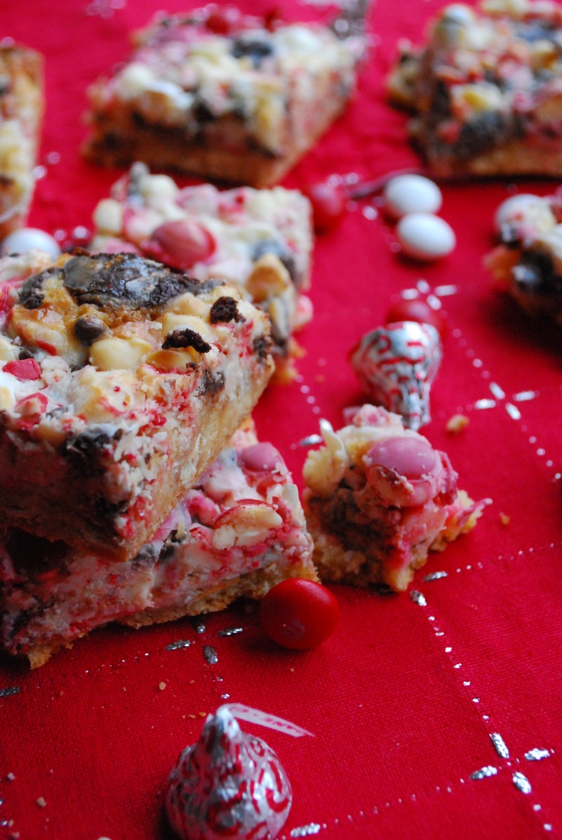 A few peppermint seven layer bars on a holiday themed background