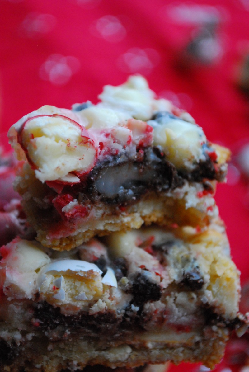 Close-up of peppermint seven layer bars with a bite missing from one to show the texture inside
