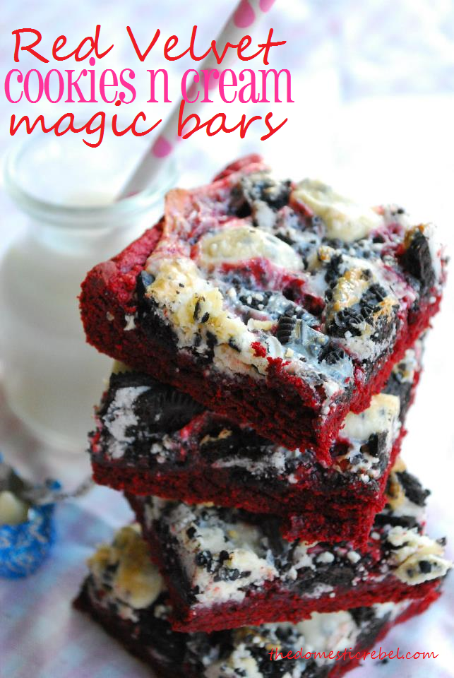 red velvet cookies & cream magic bars stacked with a glass of milk in the background