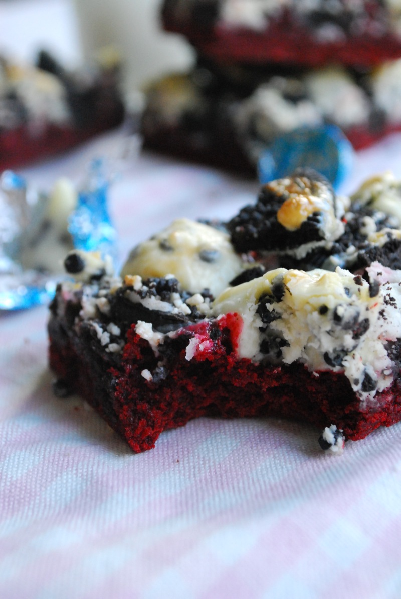red velvet cookies & cream magic bars with a bite taken out of it
