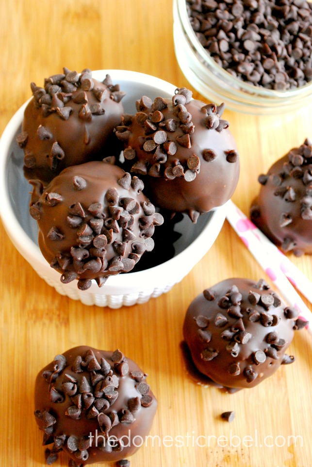 chocolate chip cookie dough brownie bombs arranged in white dish on wood background
