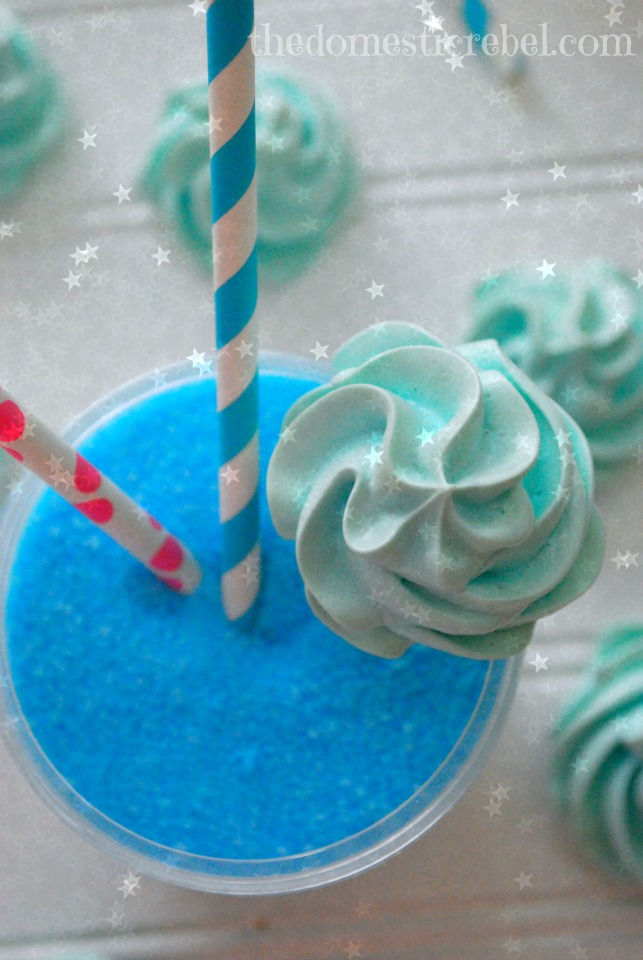 photo of cotton candy meringue balancing on a container of cotton candy sugar with stars in the background
