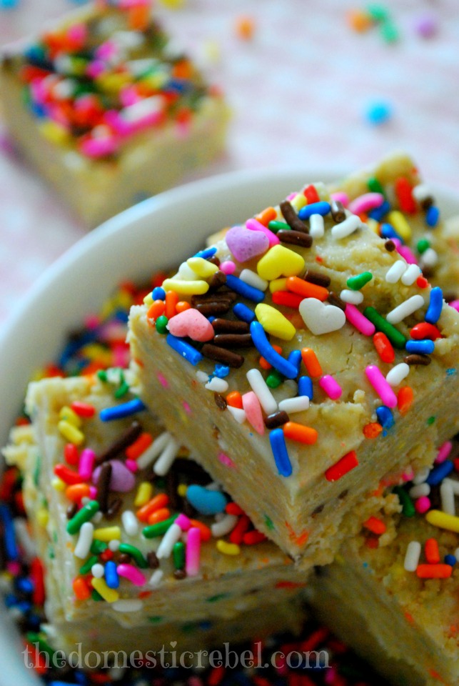 no bake cake batter squares stacked in a white plate