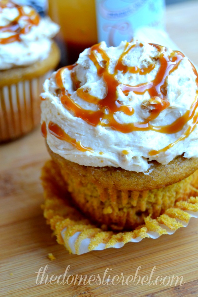 pumpkin cupcakes with pumpkin pie frosting close up on a wood background