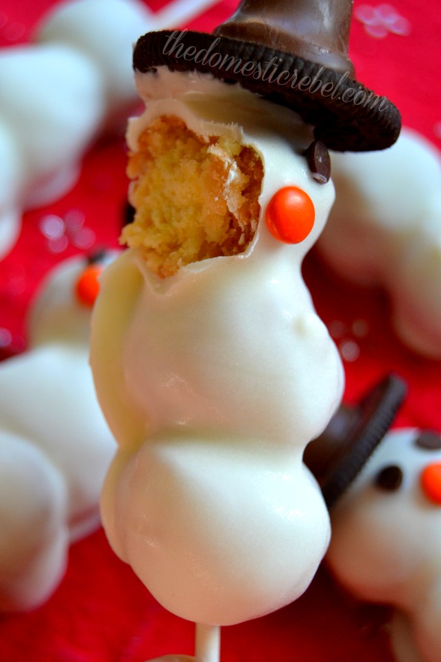 snowman donut pops with a bite removed on red background