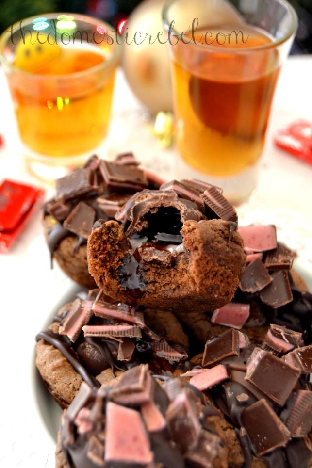 bourbon chocolate cherry cookie bites with bite removed and bourbon shots in background