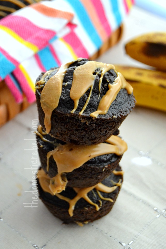 skinny chocolate peanut butter muffins stacked on white background