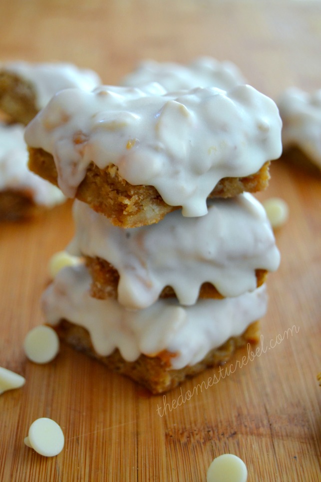 white chocolate snickers blondie bites stacked on wood background