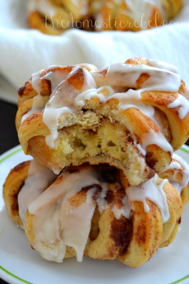 cinnamon roll-wrapped donuts stacked on white plate