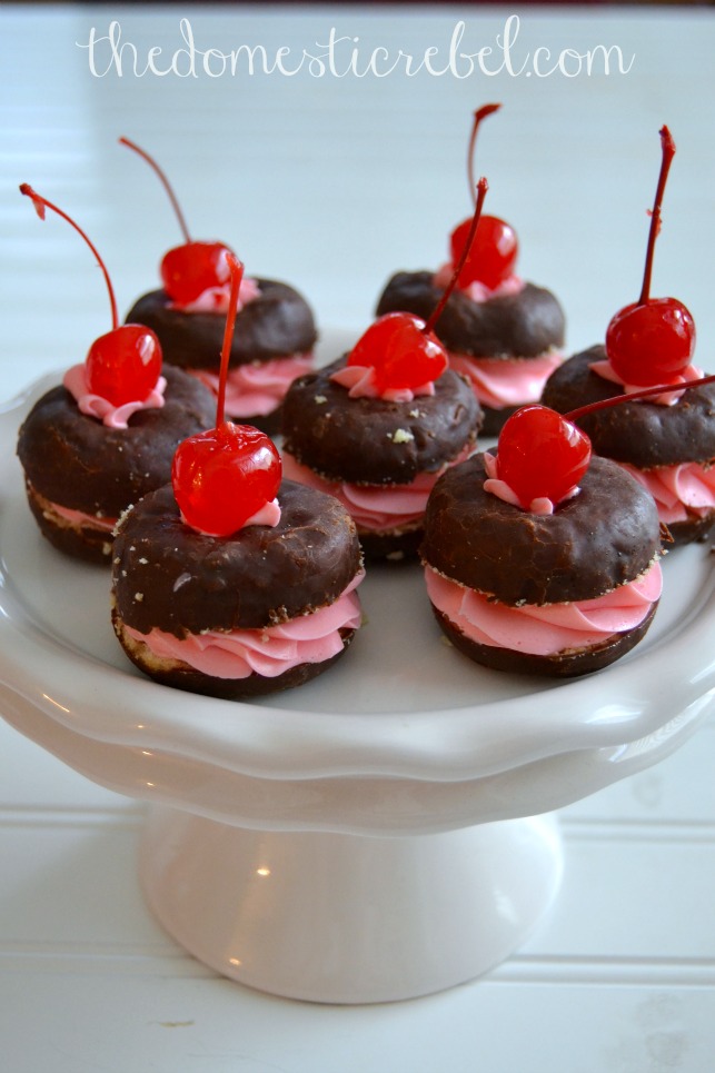 black forest donut whoopie pies on a white cake stand
