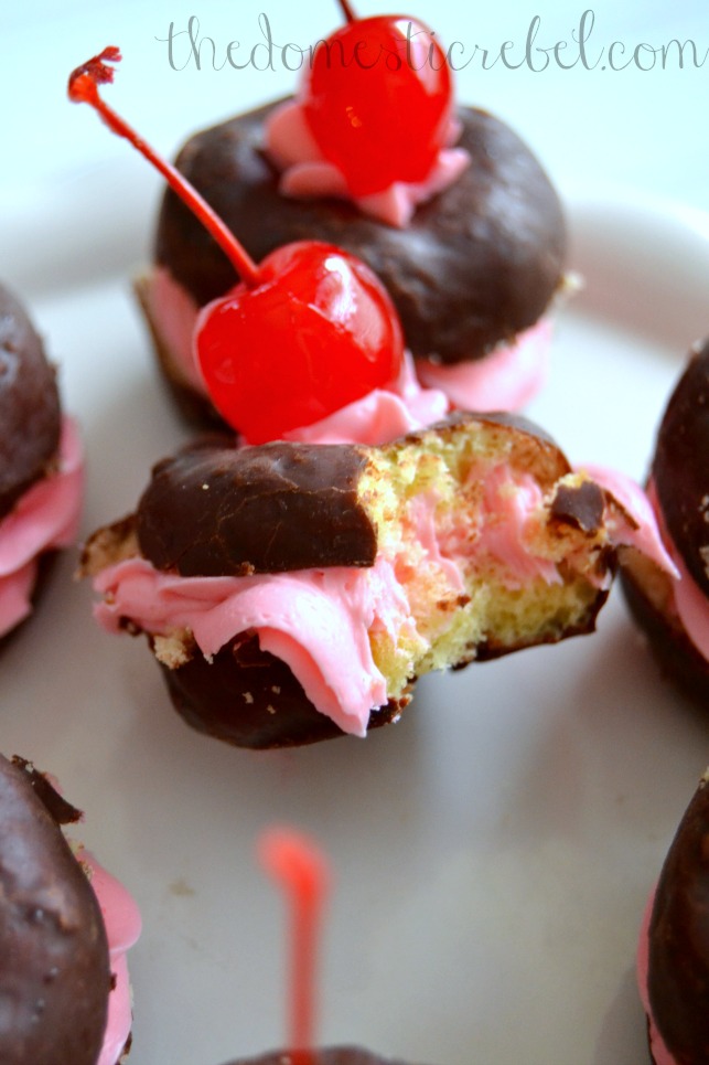 black forest donut whoopie pies with bite removed on white plate
