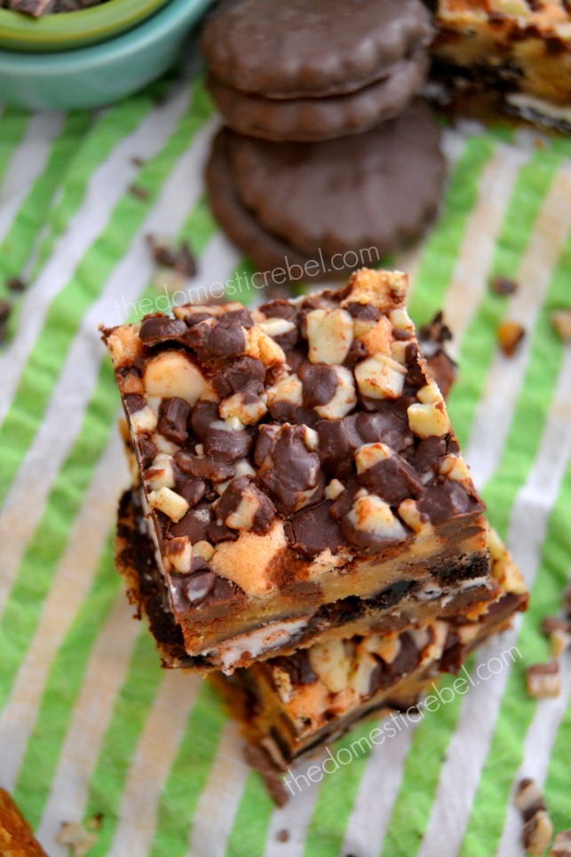 thin mint cookie bars stacked on green background