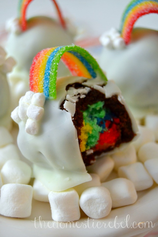 over the rainbow brownie bomb with bite removed on bed of mini marshmallows