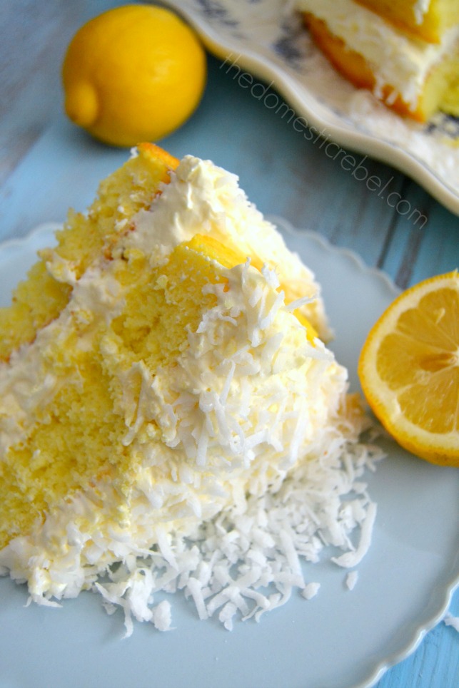 guiltless lemon coconut cake slice on blue plate with lemon in background