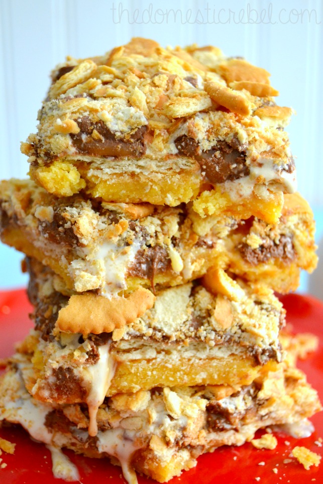 ritz cracker peanut butter caramel s'mores bars stacked on red plate