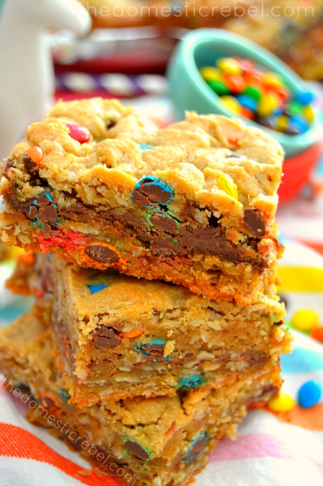 nutella-filled monster cookie bars stacked on colorful fabric