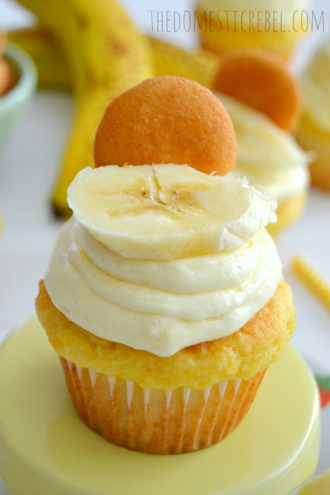 banana pudding cupcakes with cool whip pudding frosting on yellow cake stand