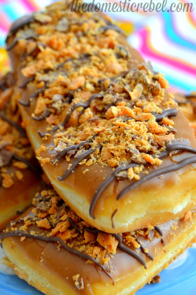 butterfinger maple bar doughnuts up close on colorful dishtowel