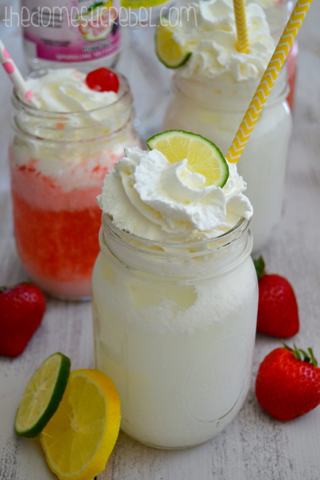sparkling italian creme sodas with limes and strawberries on white background