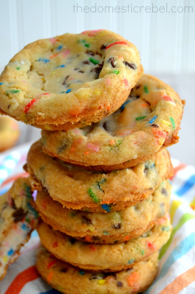 frosting filled deep dish cake batter cookies stacked on white background
