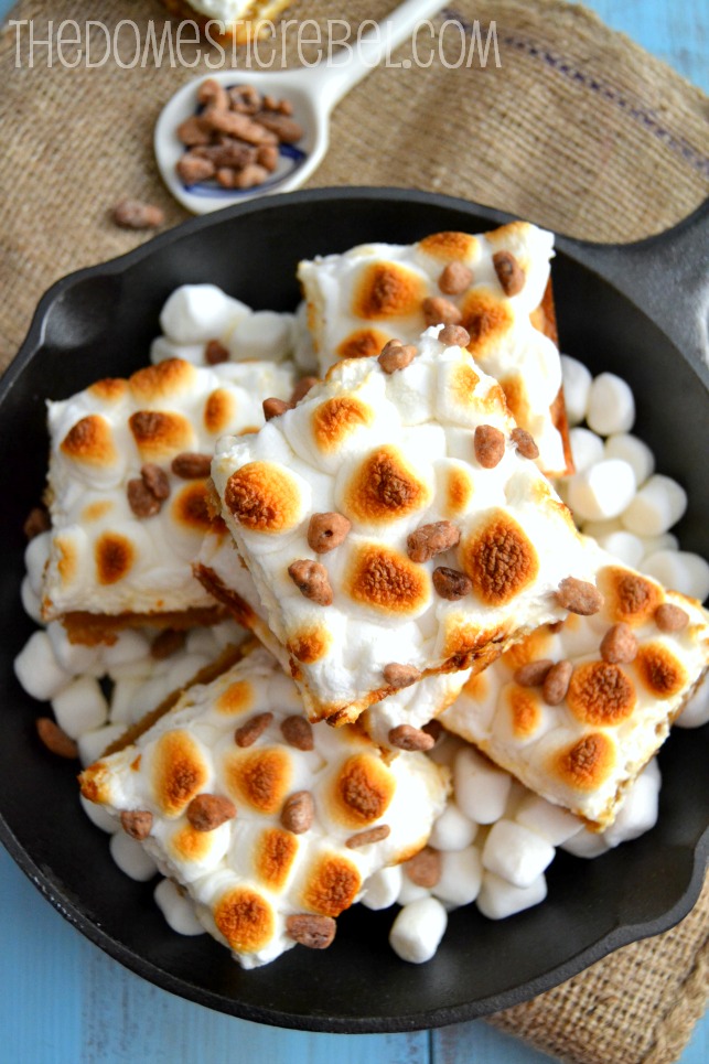 toasted marshmallow caramel butter pecan bars arranged in cast iron skillet