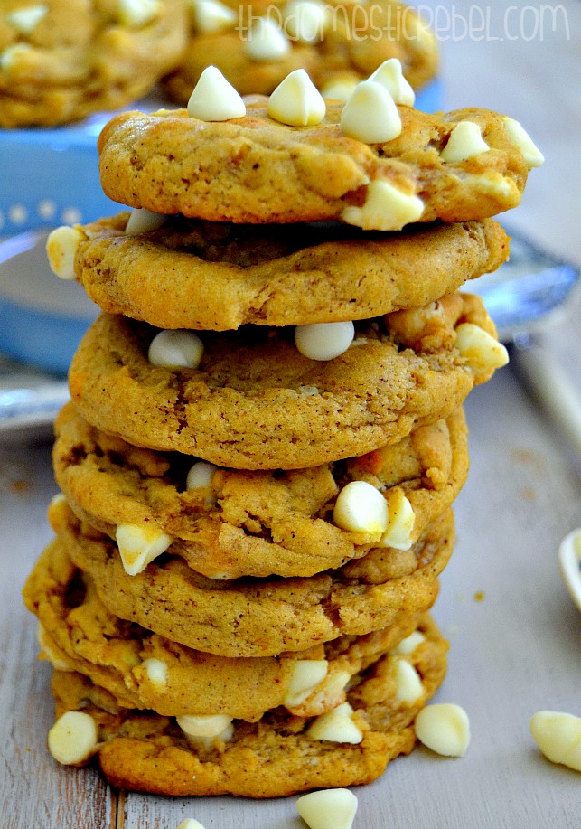 chewy pumpkin chip cookies stacked on white background