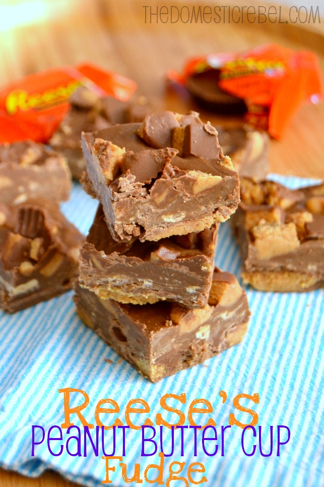 Reese's Peanut Butter Cup Fudge stacked on blue towel with candy wrappers