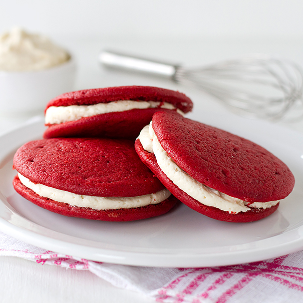 Whoopie-Pies on white plate with whisk in background