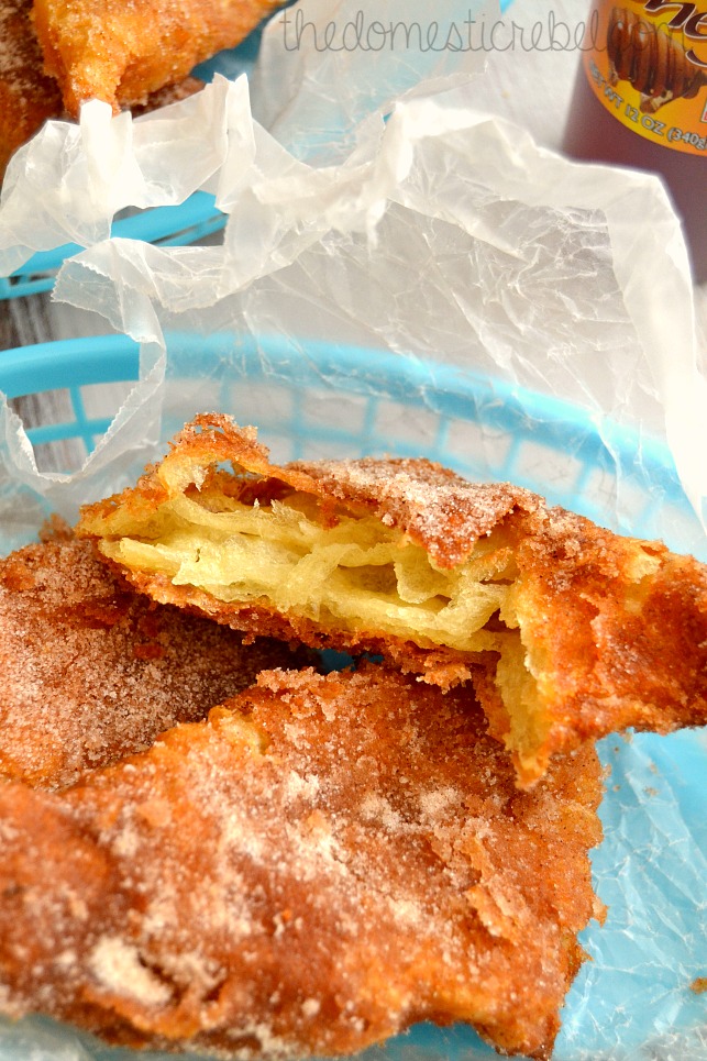 Sopapillas in a blue basket with a bite mark