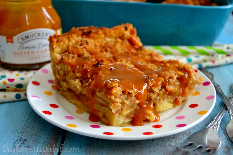 deep dish salted caramel apple pie on a polka dot plate with caramel sauce in background