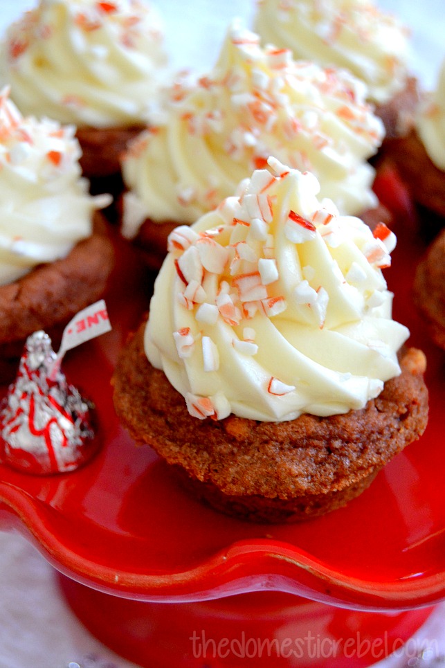 peppermint bark cheesecake cookie cups close up with hershey kiss on red cake stand
