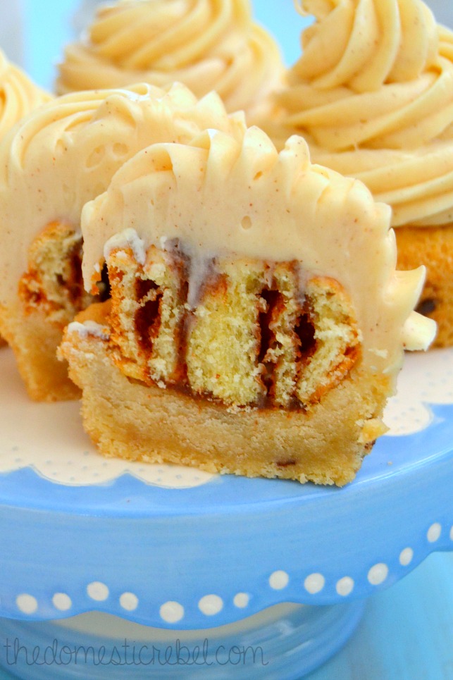 cinnamon roll cookie bites halved to show interior on blue cake stand
