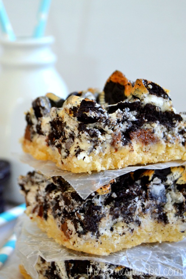 cookies n cream seven layer bars stacked up close with milk bottle in background