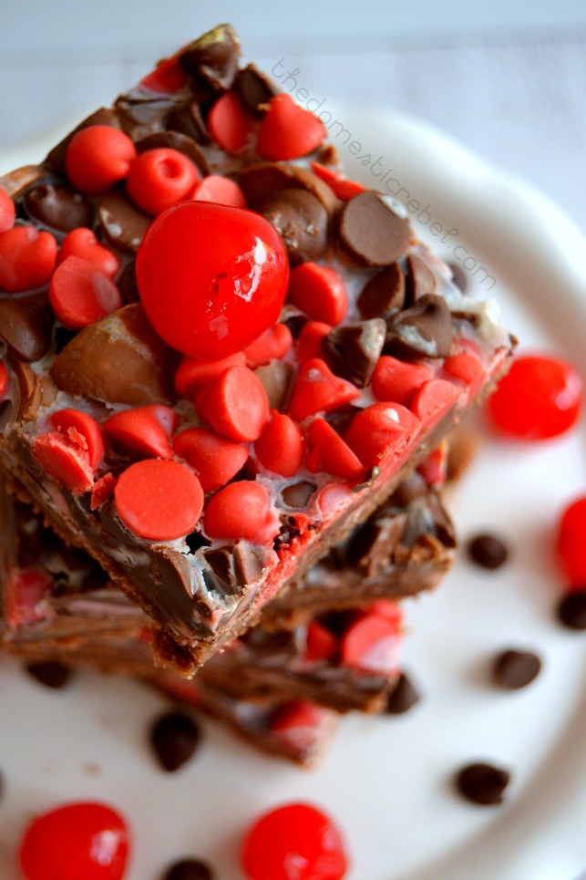 chocolate cherry seven layer bars stacked on white plate to show top of bars