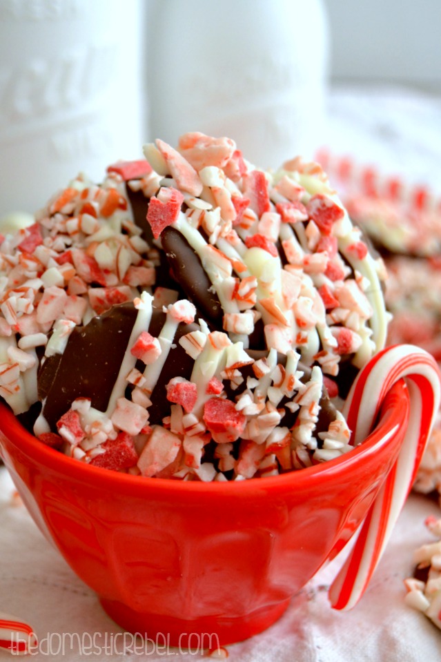 Peppermint Crunch Pretzels clustered in red bowl with a candy cane