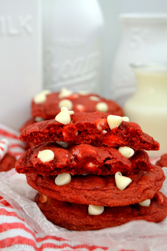 Red Velvet Cookies stacked with milk glasses in background