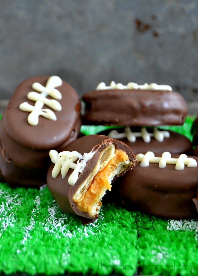 PB Cookie Dough Footballs arranged on turf with a bite removed