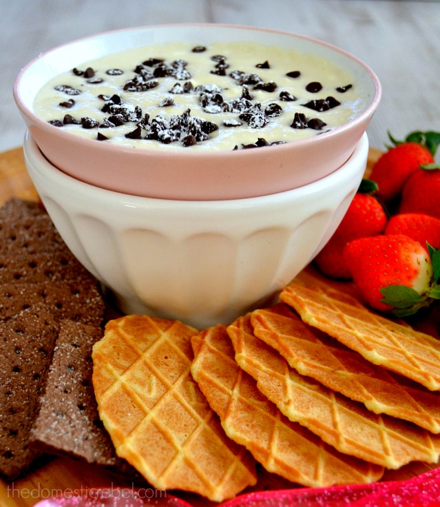 Creamy Cannoli Dessert Dip in bowl surrounded by various cookies and fruit