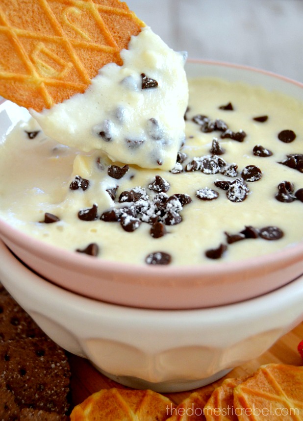 Creamy Cannoli Dessert Dip with a waffle cookie dipped inside