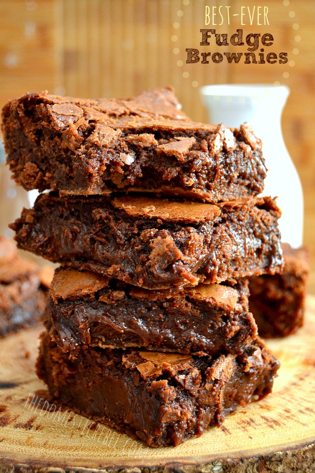 Best Ever Fudge Brownies stacked against wood background