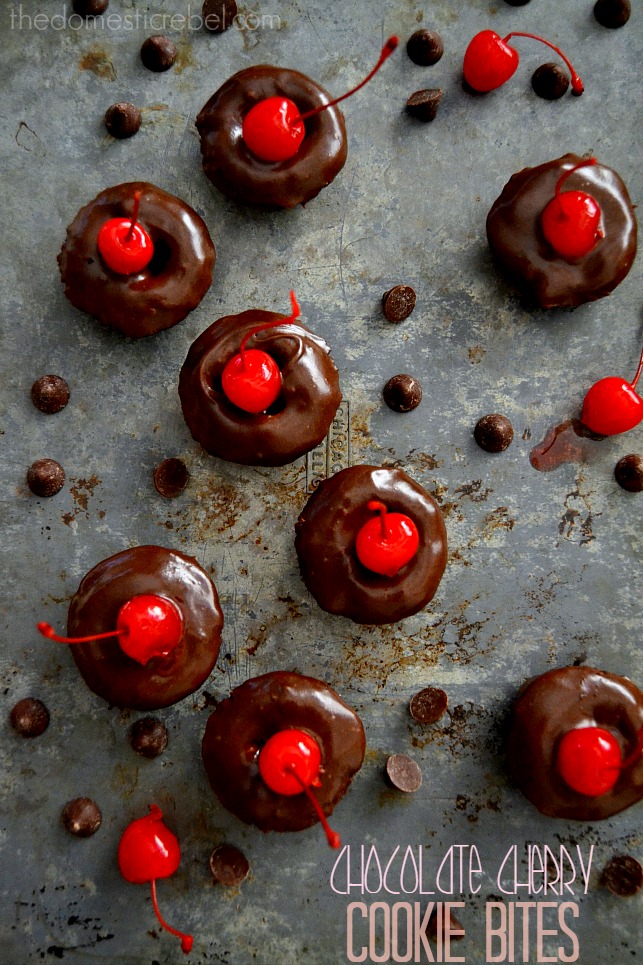 Chocolate Cherry Cookie Bites scattered with chocolate chips and cherries on metal background